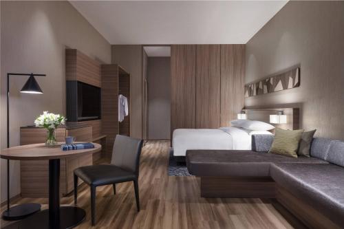a hotel room with a bed and a couch at Izu Marriott Hotel Shuzenji in Izu