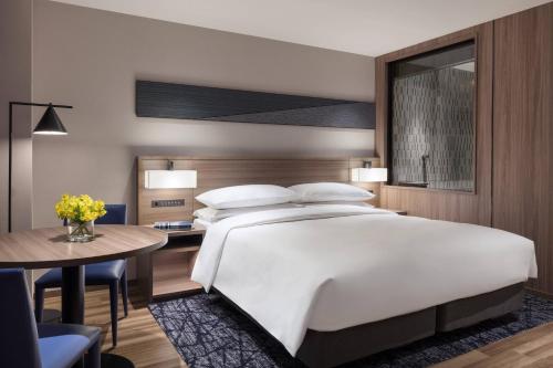 a bedroom with a large white bed and a table at Izu Marriott Hotel Shuzenji in Izu