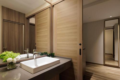 a bathroom with a sink and a mirror at Izu Marriott Hotel Shuzenji in Izu