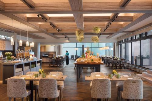 a rendering of a restaurant with tables and chairs at Izu Marriott Hotel Shuzenji in Izu