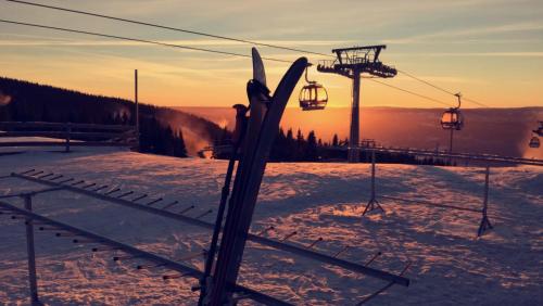 a pair of skis in the snow next to a ski lift at Koselig leilighet med Ski Bike in and out Nr 34 in Hafjell