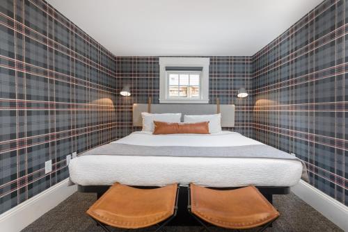 a bedroom with a large bed with two pillows at Prentiss House by Thatch in Cambridge