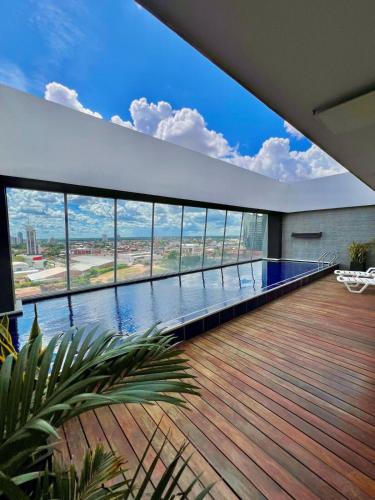 a large swimming pool in a house with a large window at DELUXE Apartamento Urbano in Santa Cruz de la Sierra