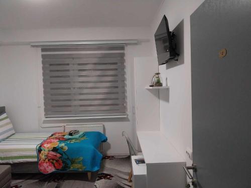 a small bedroom with a bed and a window at AUTOMOTODROM GROBNIK - Apartments and Rooms Skejić in Čavle