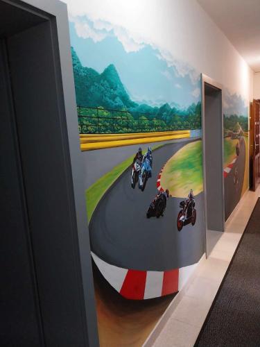 a wall mural of motorcycles on a race track at AUTOMOTODROM GROBNIK - Apartments and Rooms Skejić in Čavle