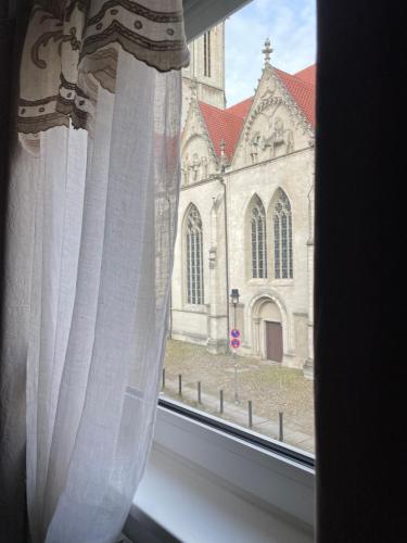 a window with a view of a church at Alte Waage in Braunschweig