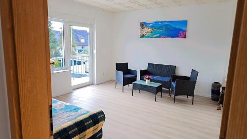 a room with chairs and a table and a balcony at Beautiful 3 Room big Apartment with kitchen and Balcony in Kerpen