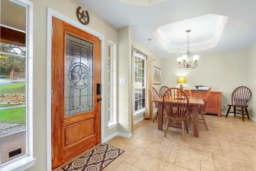 a dining room with a wooden door and a table at Something Special Too in Canyon Lake