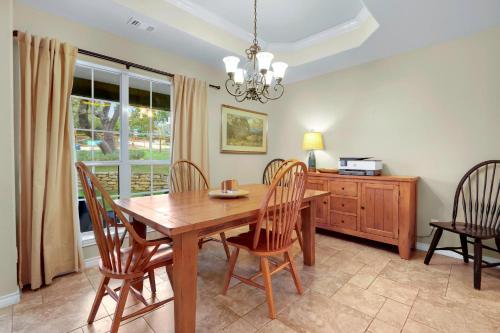 a dining room with a wooden table and chairs at Something Special Too in Canyon Lake