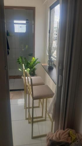 a kitchen with a table and chairs in a room at Ap do montinegro in Campina Grande