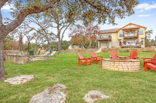 a group of red chairs in the yard of a house at Something Special Too in Canyon Lake
