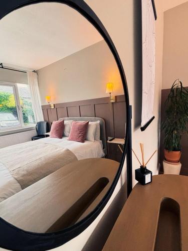 a large mirror in a bedroom with a bed at The Tower House B&B in Thomastown