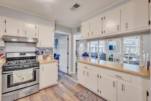 a kitchen with white cabinets and a stove at Gulf Breezes in Gulfport
