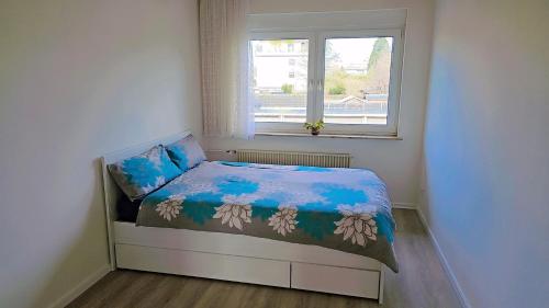 a small bedroom with a bed and a window at Beautiful 3 Room big Apartment with kitchen and Balcony in Kerpen