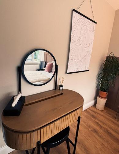 a mirror on a wall with a table and a bed at The Tower House B&B in Thomastown