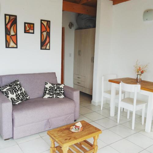 a living room with a couch and a table at La Cumbre in Sierra de los Padres
