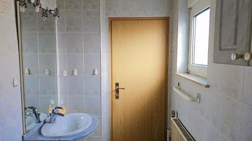 a bathroom with a sink and a mirror at Beautiful 3 Room big Apartment with kitchen and Balcony in Kerpen