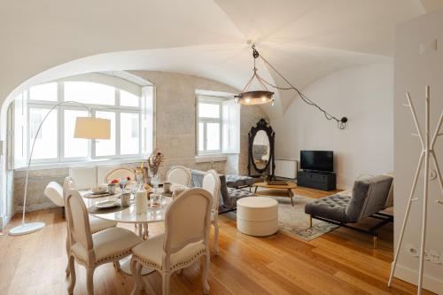 a living room with a table and chairs at Almaria - Da Corte Apartments | Chiado in Lisbon