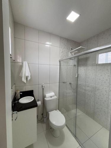 a bathroom with a toilet and a glass shower at Novo e Moderno Apartamento in Boa Vista