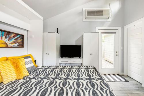 a bedroom with a bed and a flat screen tv at Modern guest house in East Atlanta Village in Atlanta