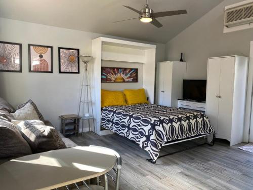 a bedroom with a bed and a couch and a tv at Modern guest house in East Atlanta Village in Atlanta