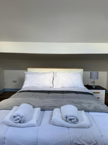 バーミンガムにあるNear Birmingham - Stylish Loft - Free Parkingのベッド1台(タオル2枚付)