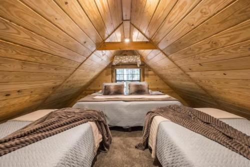 a bedroom with two beds in a wooden room at The Snug Nest Nestled in Canopy Woods in Menlo