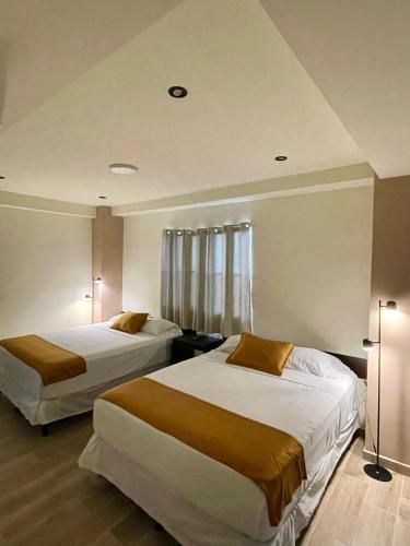 Letto o letti in una camera di Hotel Villa Serena San Benito