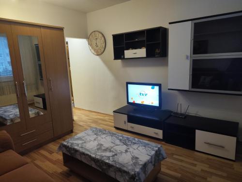 a living room with a flat screen tv on a stand at spisska nova ves apartman smizany in Smižany