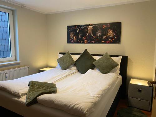 a bedroom with a bed with white sheets and pillows at J22 - Fullhouse - Apartments - Fussgängerzone - Netflix in Eisenach