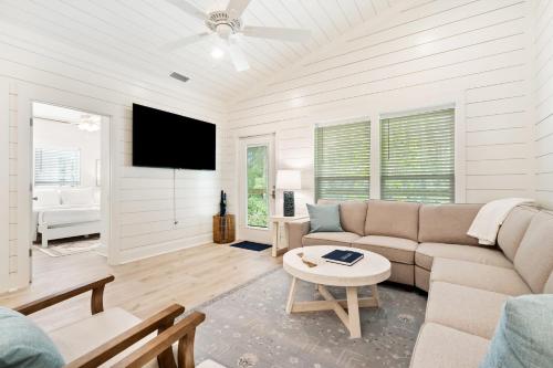a living room with a couch and a tv at Brand New Luxury Rental on Oleander Unit C in Dauphin Island