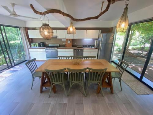 a large kitchen with a wooden table and chairs at CASA NiCO in Río Sequito