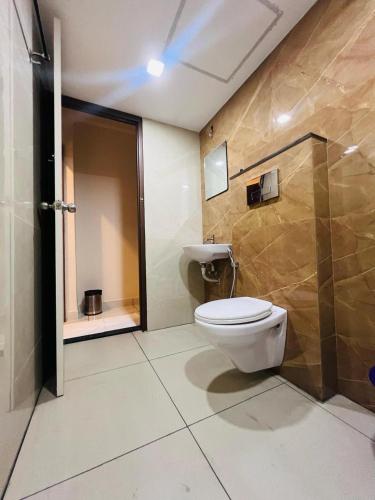 a bathroom with a toilet and a shower at GYPSY HOTEL CUSAT in Cochin