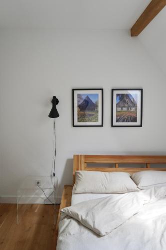 a bedroom with two framed pictures on the wall at Poręba15 in Poręba