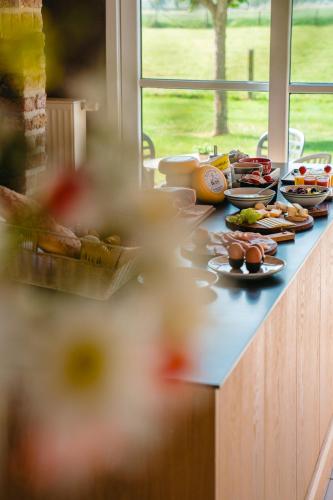 a counter with plates of food on it at hoevehotel ter haeghe in Gistel