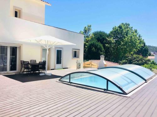 a glass swimming pool on the roof of a house at Casas do Convento in Minde