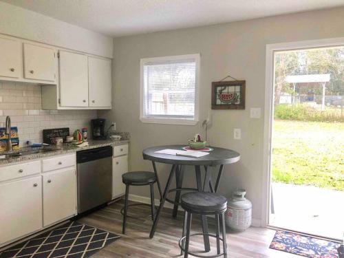 a kitchen with a small table and stools in it at Townhomes Near the Bay - #1 in Grand Bay