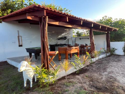 a pergola with a ping pong table and a pool table at Pipa Golfinhos Pousada in Pipa