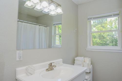 a white bathroom with a sink and a mirror at Townhomes Near the Bay - #2 in Grand Bay