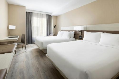 a hotel room with two beds and a desk at AC Hotel St Petersburg Downtown in St Petersburg