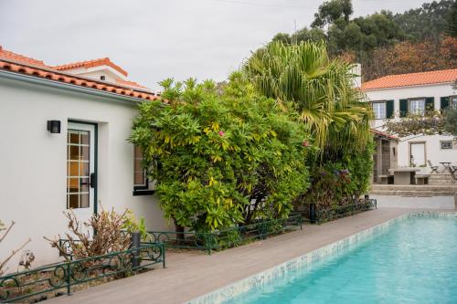 a villa with a swimming pool in front of a house at Quinta da Victória by venimar in Viana do Castelo