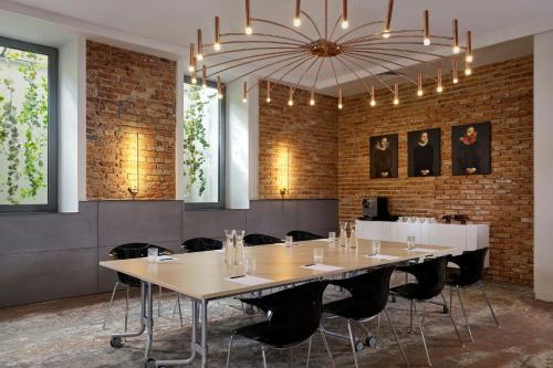 a conference room with a large table and a chandelier at Hotel Verte, Warsaw, Autograph Collection in Warsaw