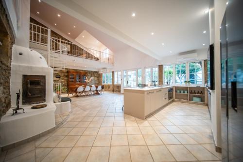 a large kitchen with a fireplace and a living room at Quinta da Victória by venimar in Viana do Castelo