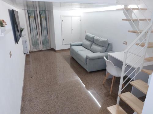a living room with a couch and a staircase at Casa Caratino in Mattinata