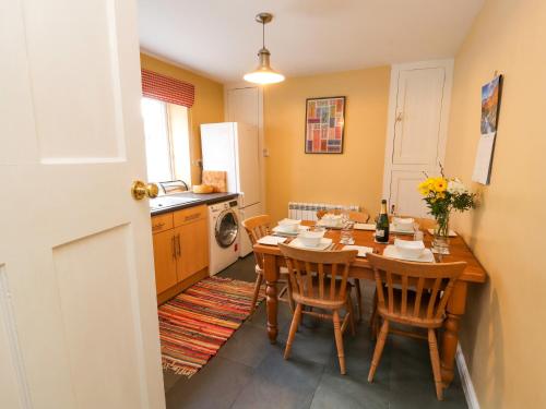 a kitchen with a wooden table and chairs in a room at Maiden Moor in Keswick