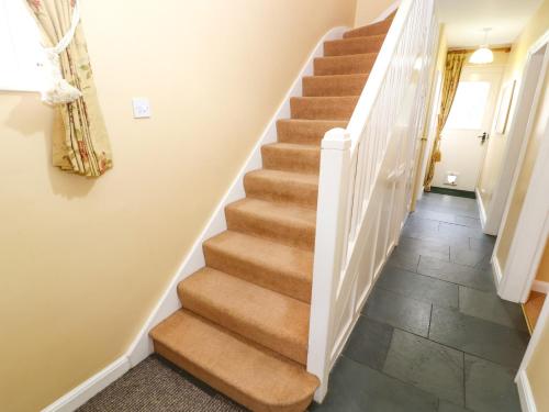 a staircase in a home with a tile floor at Maiden Moor in Keswick