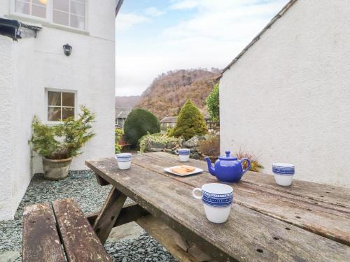 a wooden table with a tea pot and cups on it at Maiden Moor in Keswick