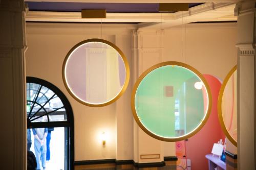 three mirrors on a wall in a room at The Rebyl, Nijmegen, a Tribute Portfolio Hotel in Nijmegen