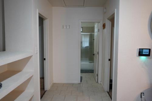 a bathroom with a hallway with a tub and a toilet at Large 4BRHome Near Zoo, Downtown, Beale Street in Memphis