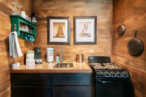 a small kitchen with a stove and a sink at Breakwater Resort in Grayland